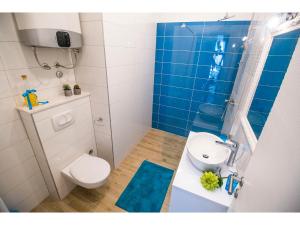 a bathroom with a toilet and a sink and a shower at IDRO Studio Apartments directly at the beach in Split