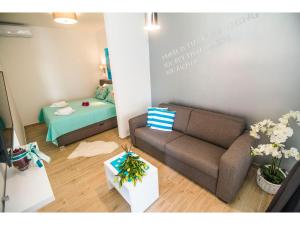 a living room with a couch and a bed at IDRO Studio Apartments directly at the beach in Split