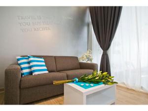 a living room with a couch and a table at IDRO Studio Apartments directly at the beach in Split