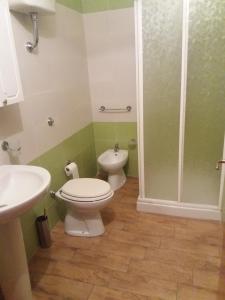 a bathroom with two toilets and a shower at Monolocali Angelica in Porto Cesareo +17 photos