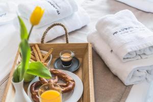 a tray with a plate of pretzels and a glass of juice at Prasonisi Villas in Kattavía