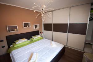 a bedroom with a large bed with a ceiling fan at Dario Room in Novigrad Istria