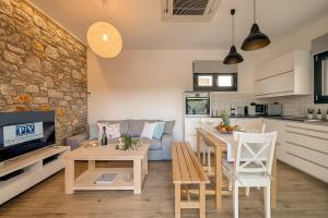 a kitchen and living room with a couch and a table at Prasonisi Villas in Kattavía