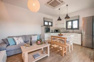 a living room with a couch and a table at Prasonisi Villas in Kattavía