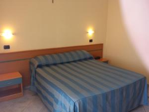 Postel nebo postele na pokoji v ubytování Hotel Pegaso