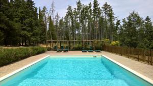 a swimming pool with two chairs and a gazebo at La Scheggia Holiday in Anghiari