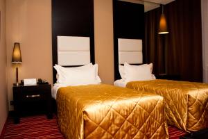 Postel nebo postele na pokoji v ubytování Manhattan Astana Hotel