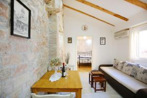 a living room with a couch and a table at Apartments Grisogono in Zadar