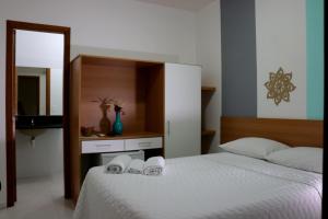 A bed or beds in a room at Pousada Solar das Conchas