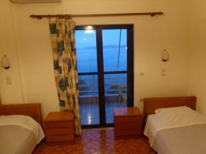 Postel nebo postele na pokoji v ubytování Poseidon Hotel