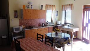 a kitchen with a table and a dining room at Penzion Rose in Štúrovo