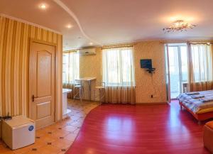 a living room with a bed and a table in it at Luxury studio in the Very center in Kherson