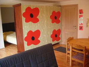 Cette chambre dispose d'un mur orné de fleurs rouges. dans l'établissement Huize Rafael, à Louvain