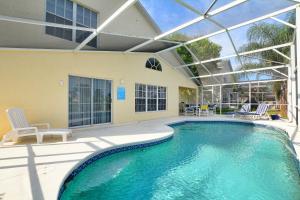 una piscina con soffitto in vetro e un patio di Mickey's Lake Villa a Orlando