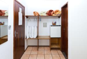 a hallway with a door and shelves of bread at Santa Maria Hotel in Cascavel