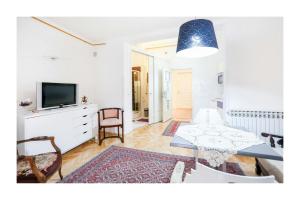 ein Wohnzimmer mit einem Tisch und einem TV in der Unterkunft Apartments and Rooms Fonty in Sarajevo