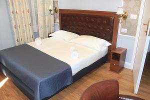 Postel nebo postele na pokoji v ubytování Hotel Aida