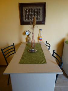 a table with a vase on top of it at Karpetis a green paradise in Psakoudia +31 photos