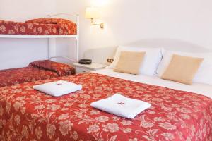 Postel nebo postele na pokoji v ubytování Hotel Le Rotonde