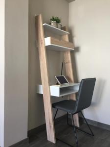 an office with a ladder and a desk and a chair at The Lighthouse Apartment in Praia da Barra