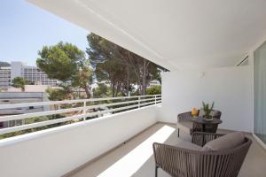 a white balcony with two chairs and a table at Canyamel Park Hotel & Spa - 4* Sup - Adults only (+16) in Canyamel