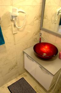 a red sink sitting on a counter in a bathroom at KonukEvim Meşrutiyet in Ankara
