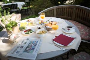 a white table with food and drinks on it at Hotel Heiligenstein in Baden-Baden