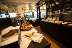 a bakery with a table with bread and other foods at Hotel Heiligenstein in Baden-Baden