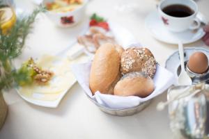 a table with a basket of pastries and a cup of coffee at Hotel Heiligenstein in Baden-Baden