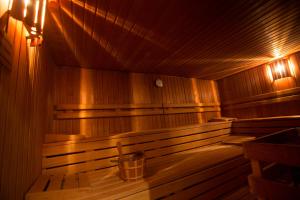 an empty wooden sauna with a bucket in it at Hotel Heiligenstein in Baden-Baden
