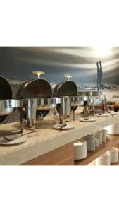 a row of food stations at a beach with the ocean at Hotel Asri Sumedang in Sumedang