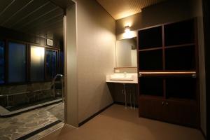 a bathroom with a sink and a shower at Hotel Housei in Yamanouchi
