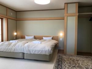 Posteľ alebo postele v izbe v ubytovaní Tsuru Apartments