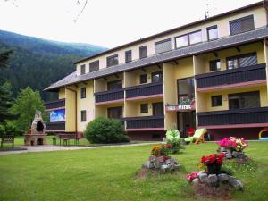 a large building with flowers in a yard at Ski Vital Apartments in Sankt Michael im Lungau