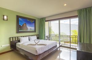a bedroom with a large bed and a balcony at Krabi Home Town Boutique in Krabi