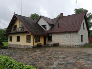 a large white house with a red roof at Bebru pirts in Vecbebri