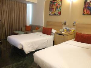 Lemon Tree Hotel, Udyog Vihar, Gurugram tesisinde bir odada yatak veya yataklar