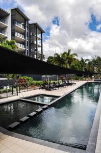 a pool of water in front of a building at The Bay Apartments in Hervey Bay