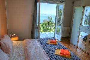 a bedroom with a bed with two towels on it at Apartman Lena in Opatija