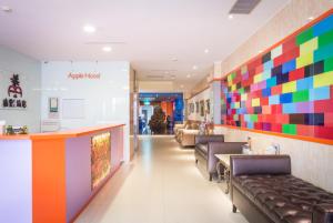 a waiting room with a colorful accent wall at Apple Hotel in Taitung City