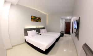 Voodi või voodid majutusasutuse Urban Style Hotel Lampung, Azana Hotels Collection toas