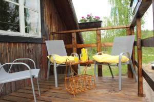 a patio with two chairs and a table on a deck at Hommik House in Otepää