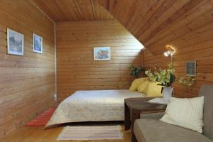 a bedroom with a bed and a couch in a room at Hommik House in Otepää