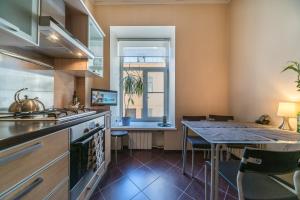 a kitchen with a counter and a table with chairs at 9th Corner in Saint Petersburg