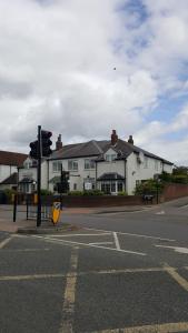 an intersection with a traffic light in front of a house at Balkan Lodge Oxford in Oxford