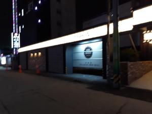 a building with a sign on the side of it at night at Hotel Chicago in Changwon
