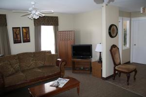 uma sala de estar com um sofá e uma televisão em The Country Inn Motel em Gander