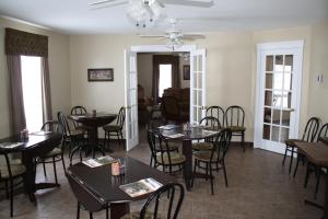 a dining room with tables and chairs at The Country Inn Motel in Gander