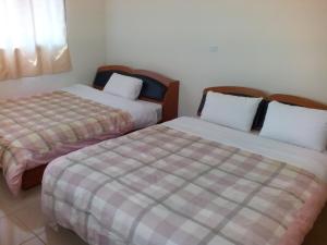 two beds sitting next to each other in a room at Sky Water in Puli