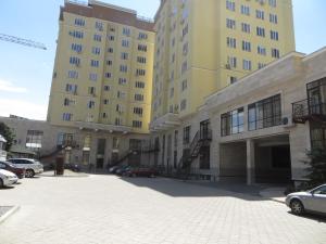 un estacionamiento frente a dos edificios altos en Best-Bishkek City Apartment, en Bishkek